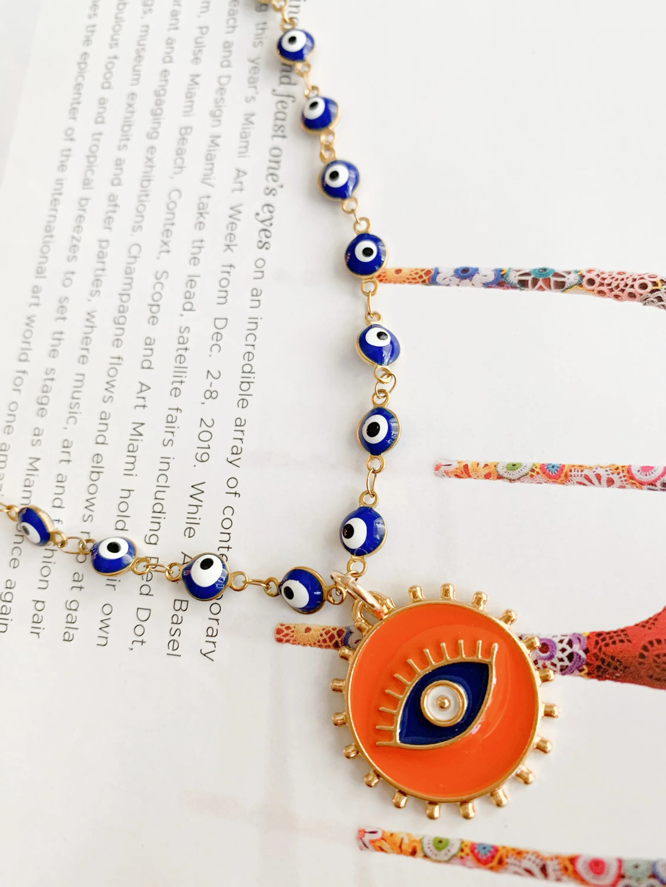 Orange pendant and blue evil eye necklace